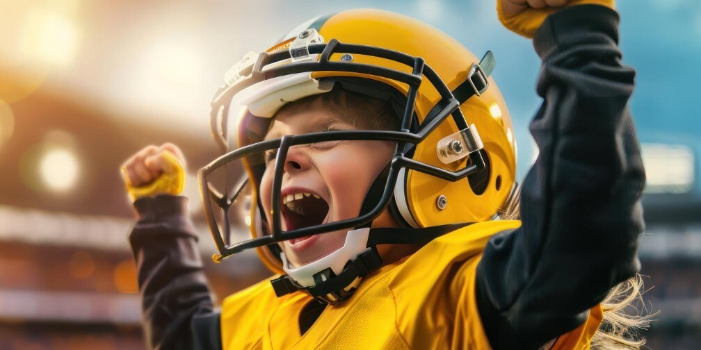 young football player in his uniform celebrating during game