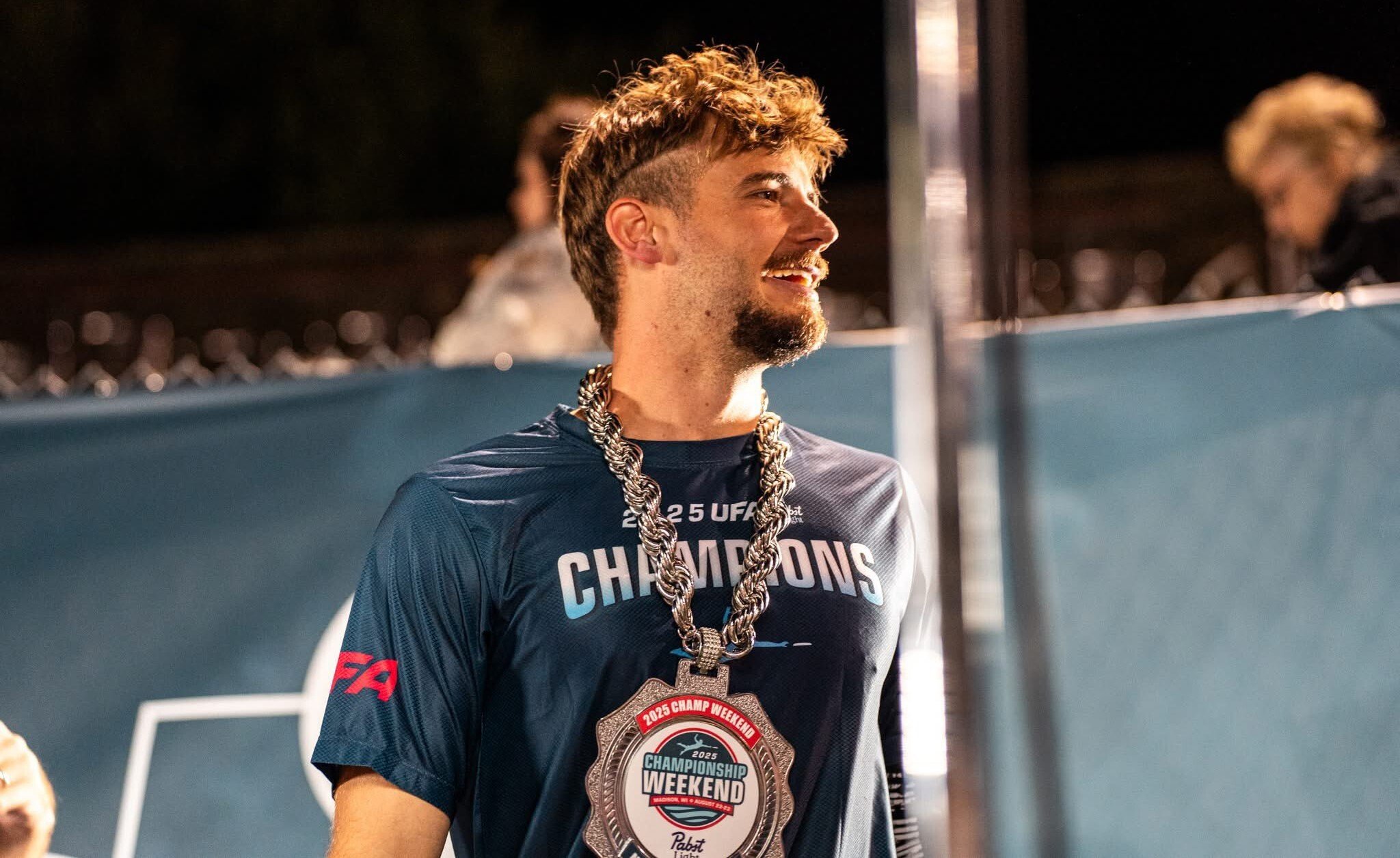 athlete wearing custom championship chain with large emblem