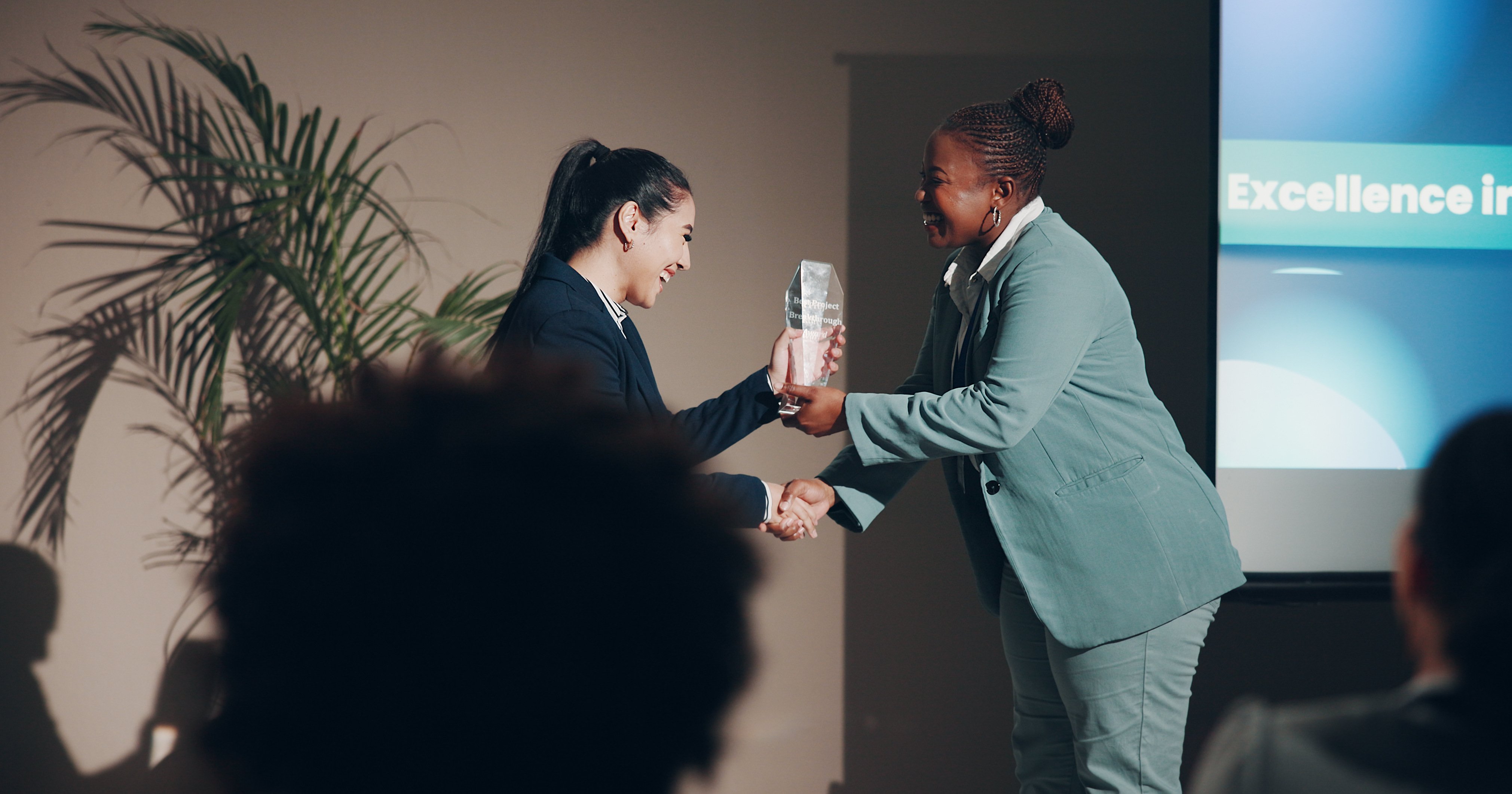 woman receiving a custom award on stage 