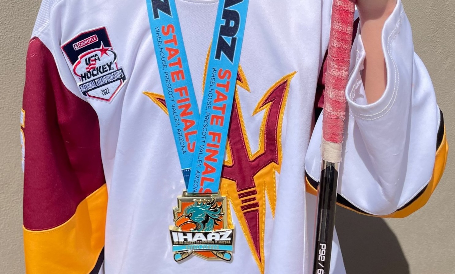 hockey player with custom hockey medal around his neck